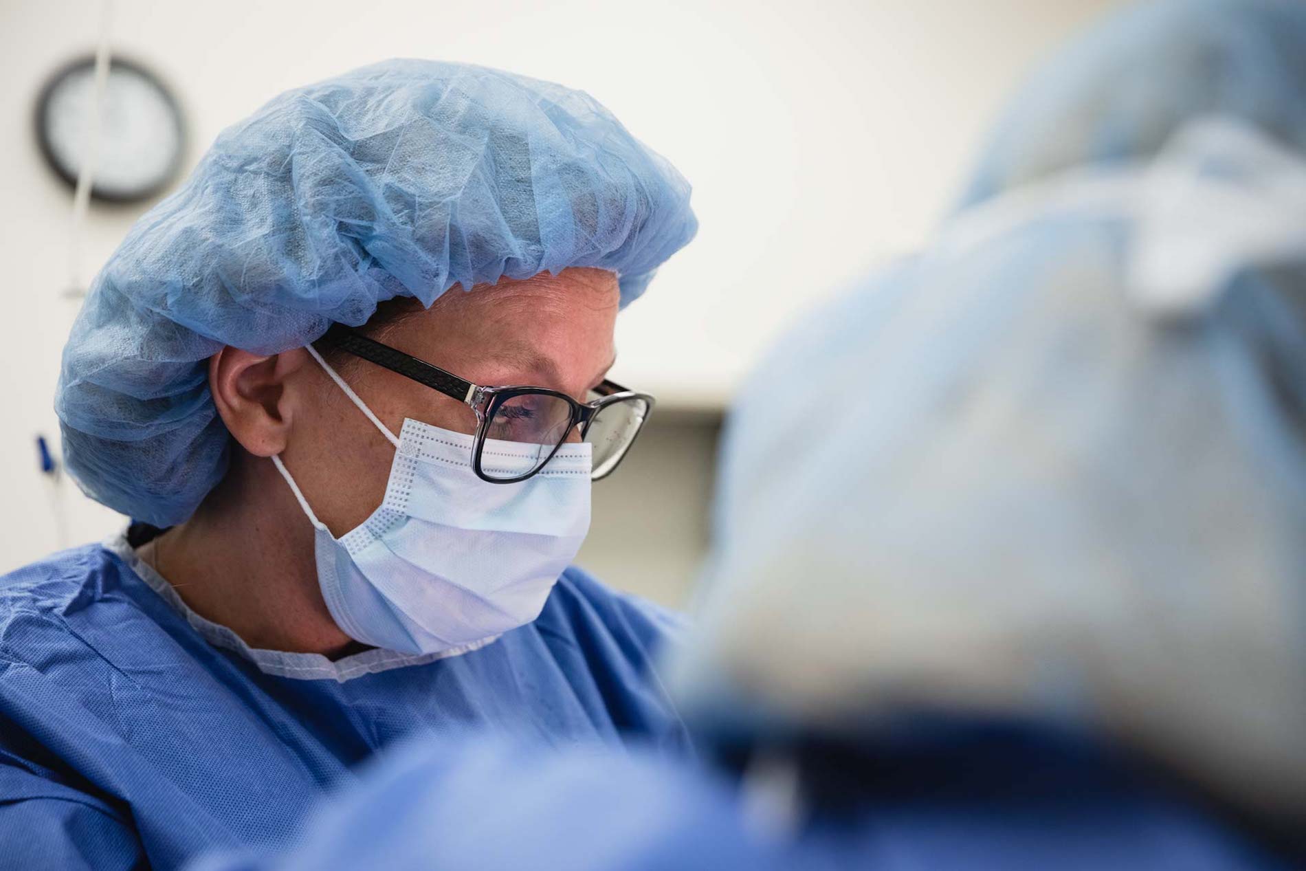 A surgeon operates for double chin surgery